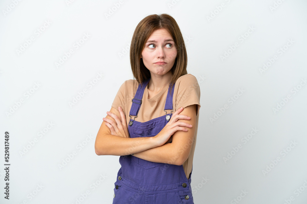 Young English woman isolated on white background making doubts gesture while lifting the shoulders Young English woman isolated on white background making doubts gesture while lifting the shoulders