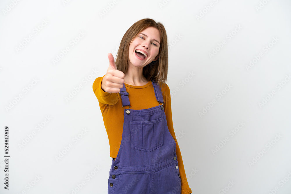 Young English woman isolated on white background with thumbs up because something good has happened Young English woman isolated on white background with thumbs up because something good has happened