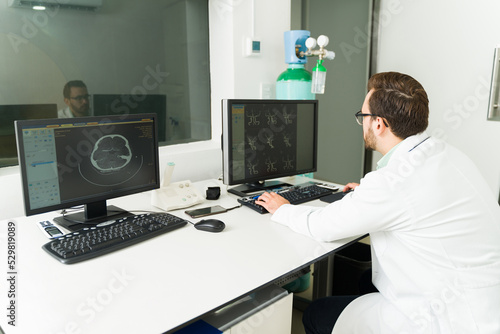 Radiologist looking at the brain resonance in the computer at the lab