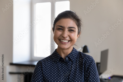 Happy beautiful young Indian office employee woman head shot portrait. Pretty millennial businesswoman, business leader, entrepreneur, manager girl looking at camera, smiling, laughing