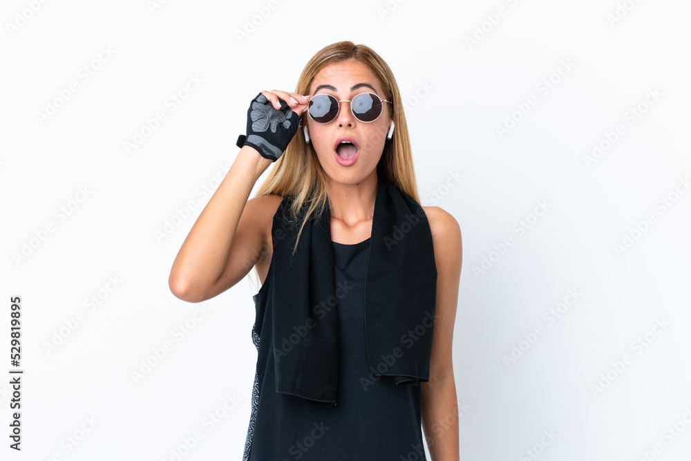 Blonde Uruguayan sport girl isolated on white background with glasses and surprised Blonde Uruguayan sport girl isolated on white background with glasses and surprised