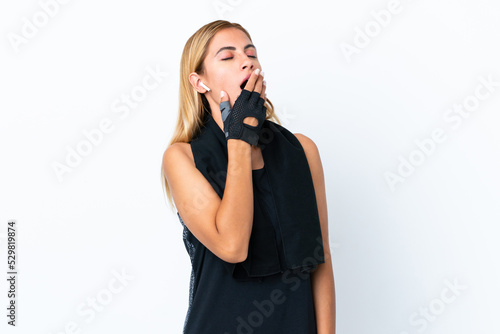 Blonde Uruguayan sport girl isolated on white background yawning and covering wide open mouth with hand