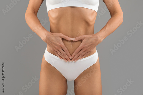 Love My Body. Closeup Of Slim Female In White Underwear Making Heart Gesture With Hands Near Belly