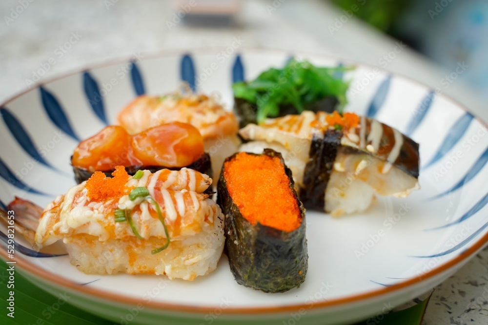 Sushi set with various faces is simple Japanese food. Delicious seafood. sushi restaurant concept Sushi set with various faces is simple Japanese food. Delicious seafood. sushi restaurant concept