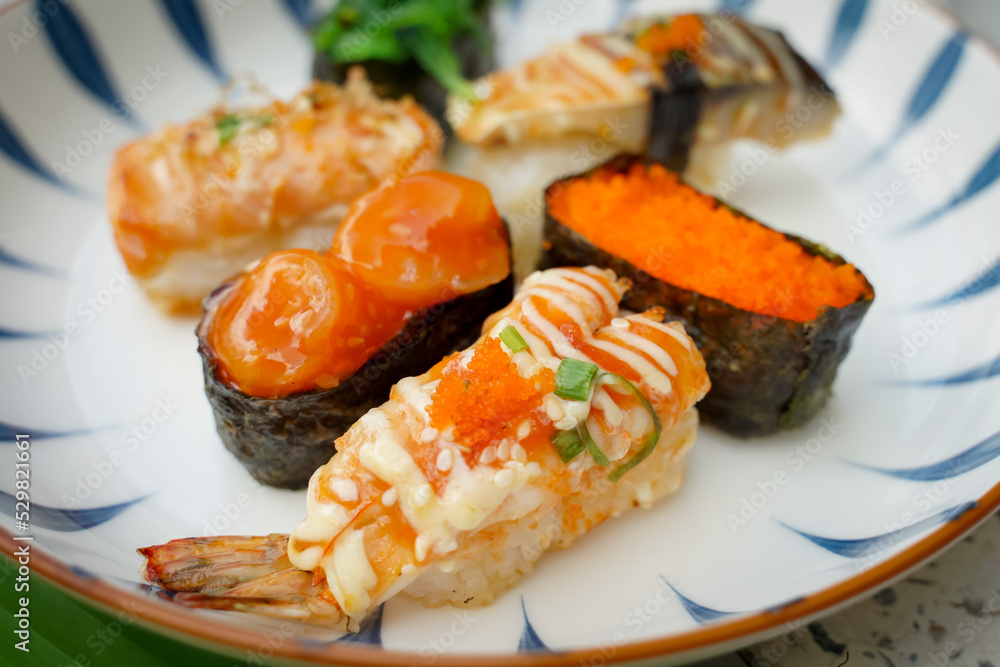 Sushi set with various faces is simple Japanese food. Delicious seafood. sushi restaurant concept Sushi set with various faces is simple Japanese food. Delicious seafood. sushi restaurant concept