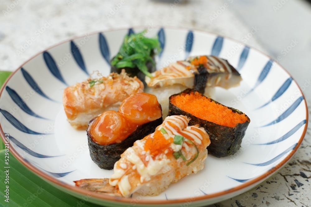 Sushi set with various faces is simple Japanese food. Delicious seafood. sushi restaurant concept Sushi set with various faces is simple Japanese food. Delicious seafood. sushi restaurant concept