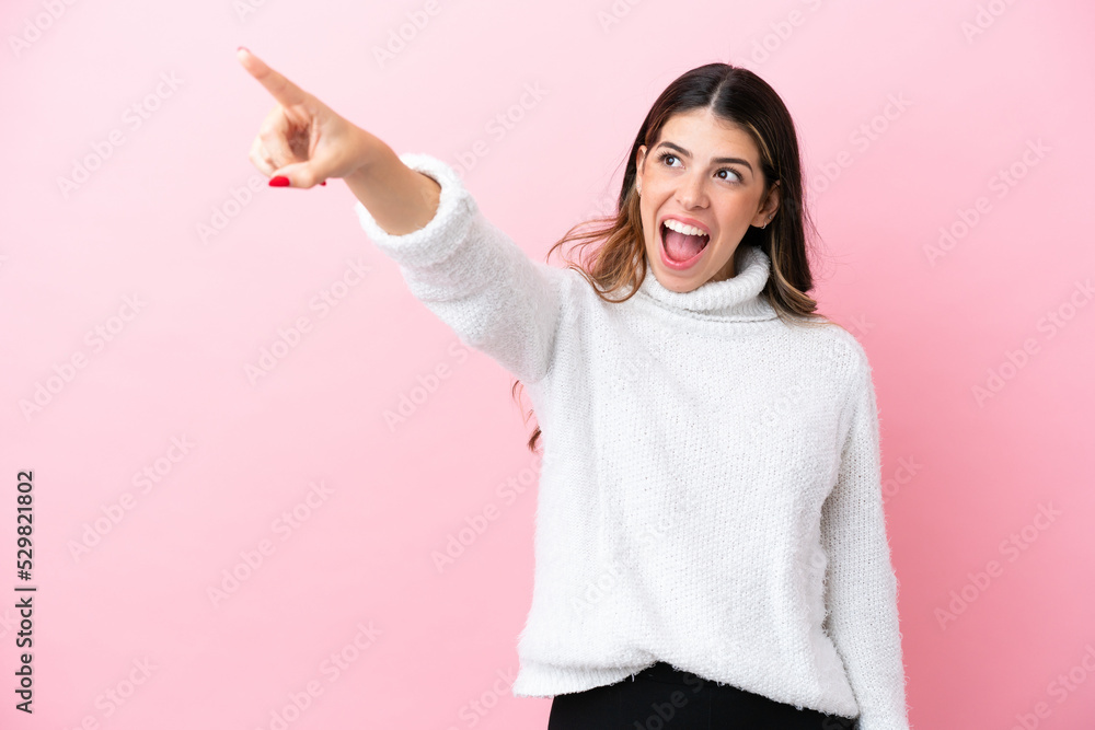 Young Italian woman isolated on pink background pointing away Young Italian woman isolated on pink background pointing away