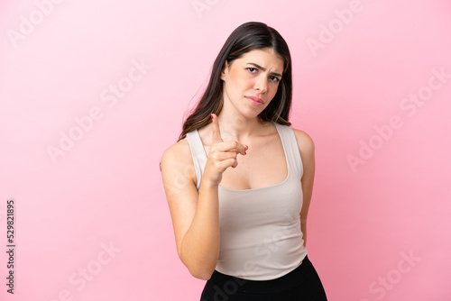 Young Italian woman isolated on pink background frustrated and pointing to the front