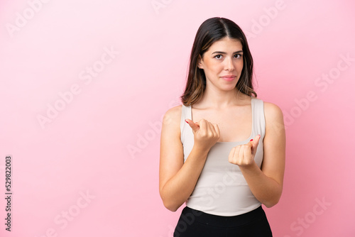 Young Italian woman isolated on pink background making money gesture but is ruined