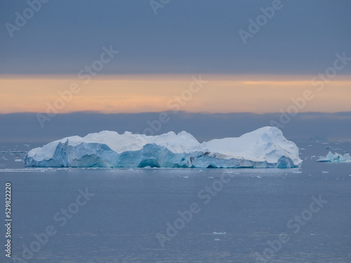 Enormous icebergs seen during the midnight sun, Disko Bay north of the Artic Circle near Ilulissat, Western Greenland © Luis