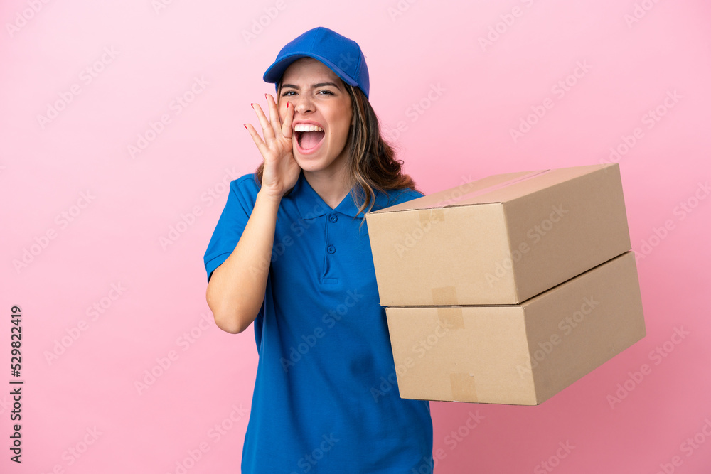 Delivery Italian woman isolated on pink background shouting with mouth wide open Delivery Italian woman isolated on pink background shouting with mouth wide open