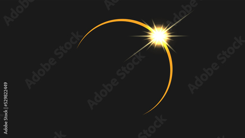 A solar eclipse with a glare from the appearing sun.