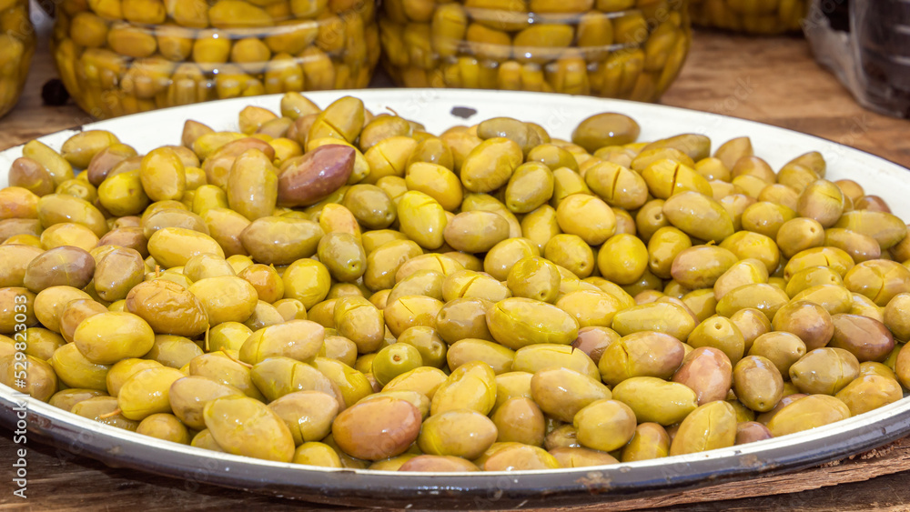 Green olives are sold at the street market Close-up