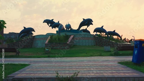 Beautiful fountain with dolphin statues in the park in Bahria Town, Islamabad, Pakistan photo