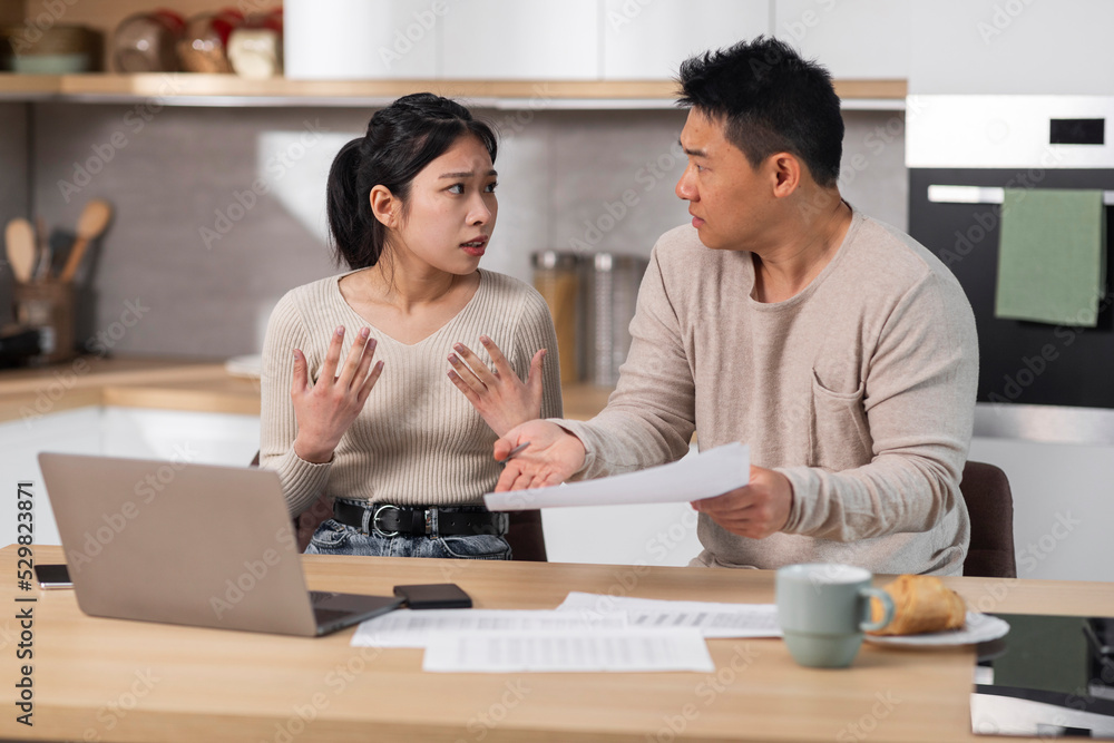 Angry husband shouting at his wife, checking spendings Angry husband shouting at his wife, checking spendings