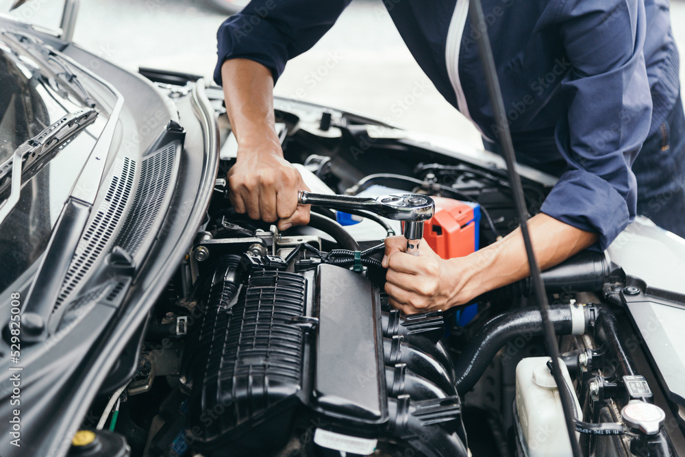 Automobile mechanic repairman hands repairing a car engine automotive workshop with a wrench, car service and maintenance,Repair service.