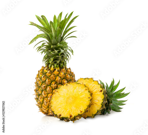 fresh whole pineapple fruit with slices on white background