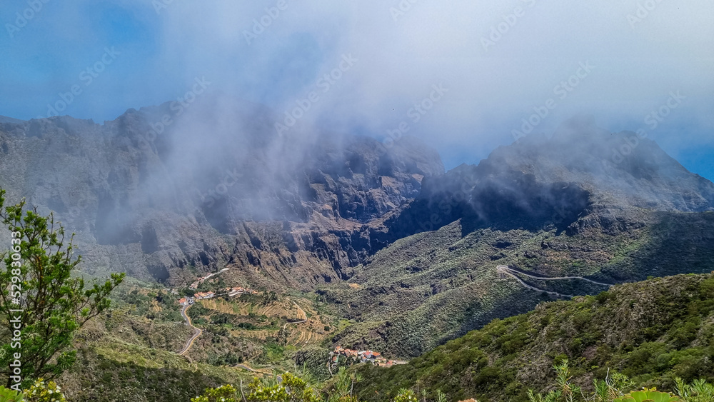 Scenic view on the steep canyon of the Teno mountain massif, Tenerife, Canary Islands, Spain, Europe. Hiking trail between village Masca and Santiago del Teide. View from Cruz de Gala. Clouds coming