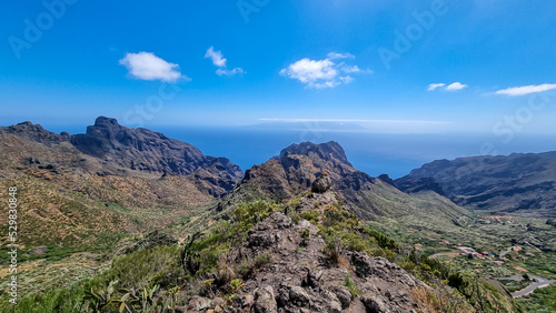 Scenic view on the steep canyon of Teno mountain massif, Tenerife, Canary Islands, Spain, Europe. Hiking trail between village Masca and Santiago del Teide. Mountain road next to Roque de la Fortaleza