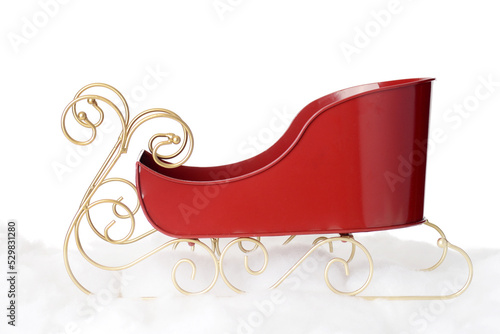 closeup metal santa sleigh with gold runners on snow photo
