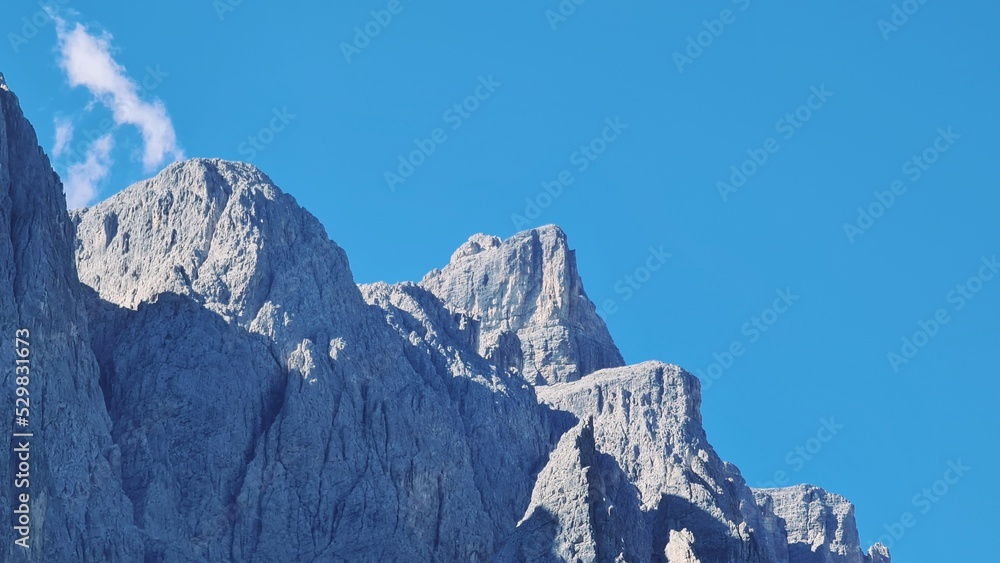 Val Badia, Italy-July 18, 2022: The italian Dolomites behind the small village of Corvara in summer days with beaitiful blue sky in the background. Green nature in the middle of the rocks.