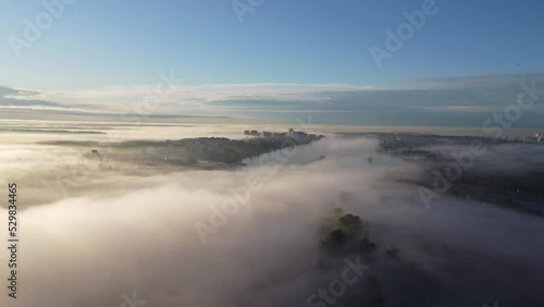 Drone aerial view on a foggy morning over the Neva River, near St. Petersburg, Russia. Beautiful summer dawn foggy landscape