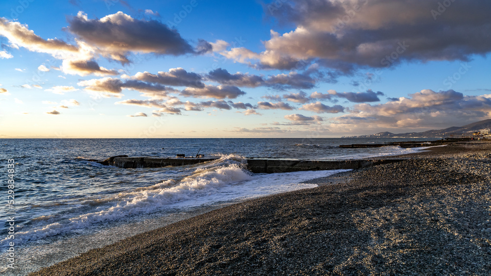 view of the city of Sochi from Adler against the background of the sea surf and sunset sky