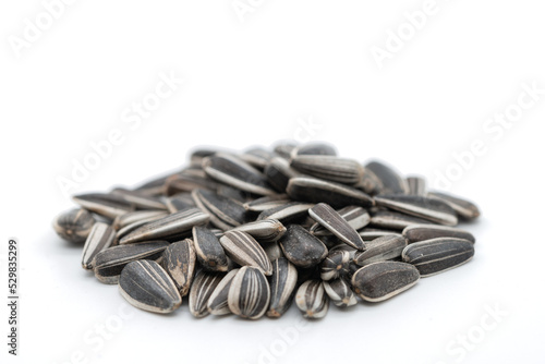 Sunflower seeds accumulation on white background, cropped image