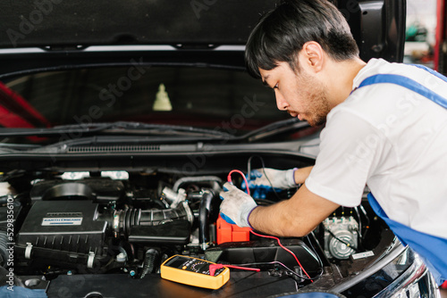 Asian Auto mechanic is diagnosing the problem with engine to repair at the shop, Car Service Center and Automobile Maintenance