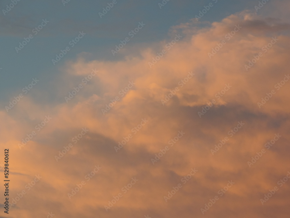 Dramatic sunset with blue sky and orange clouds