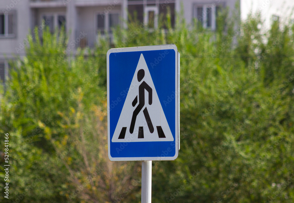 Pedestrian triangle road sign blue background Pedestrian triangle road sign blue background