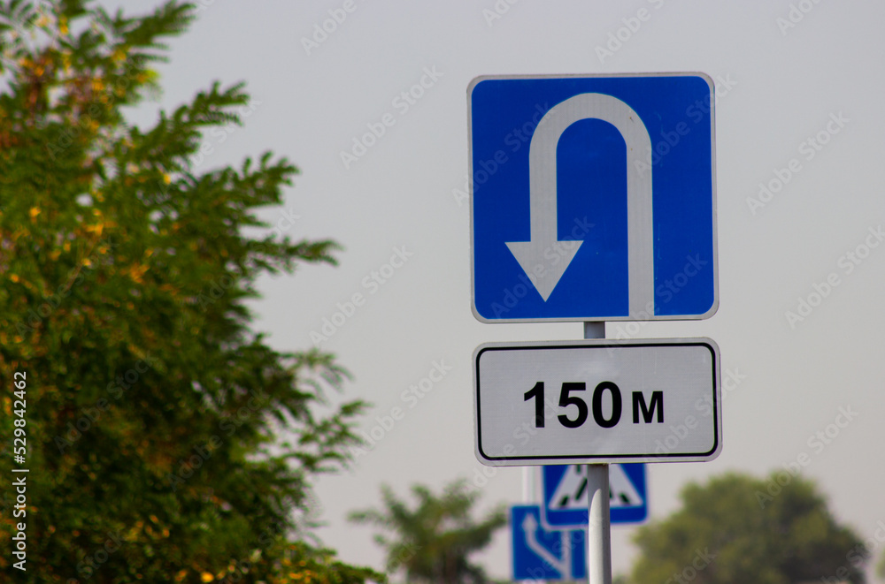 traffic direction sign white reverse arrow on blue background traffic direction sign white reverse arrow on blue background