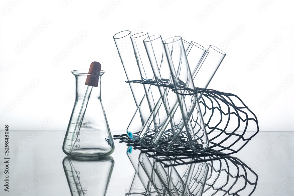 flask with lab glassware and test tubes in chemical laboratory background, science laboratory research and development concept