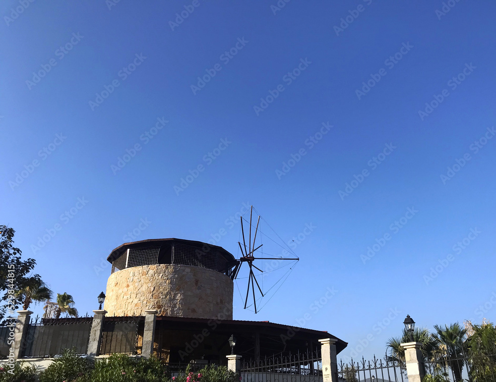 Windmill. The photo shows a windmill against a blue sky.