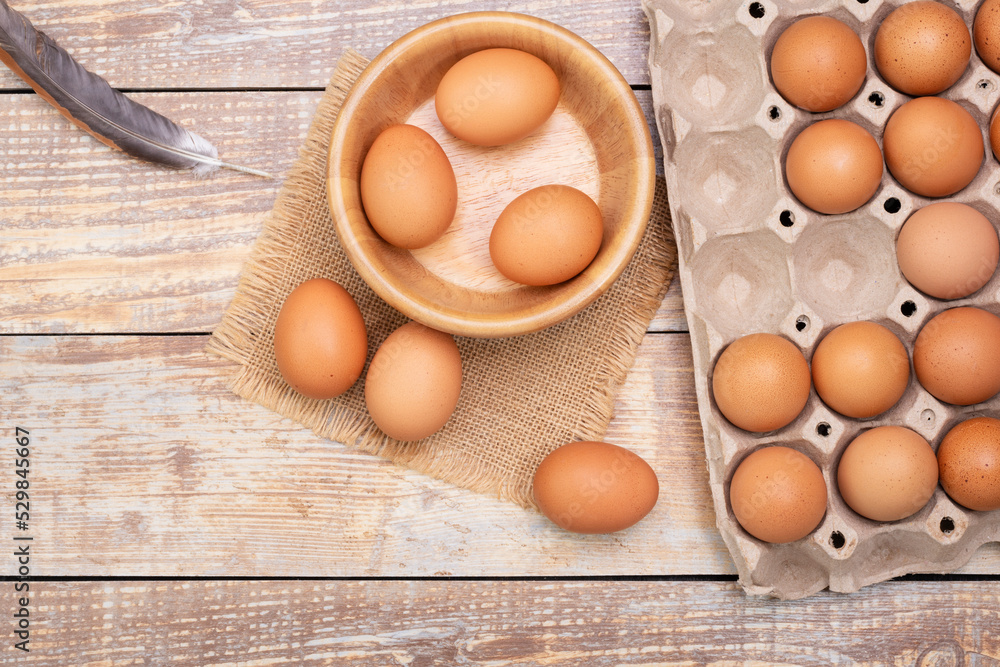 fresh chicken eggs in a wooden bowl Fresh organic eggs from rural farms. put on a wooden table in the room