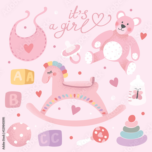A set of items for a newborn girl. Toy horse, pyramid, ball, bib, teddy bear, milk bottle, nipple, rattle, cubes with letters of the English alphabet. Lettering It's a girl
