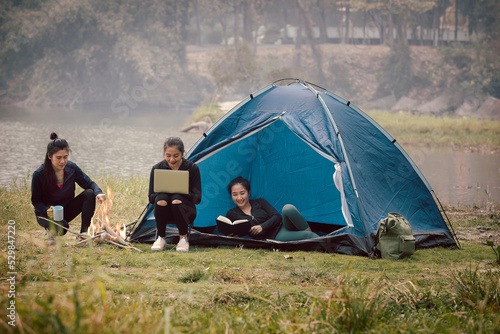 Group of Asian pretty woman camping by the tent. Outdoor activity, adventure travel, holiday vacation concept.