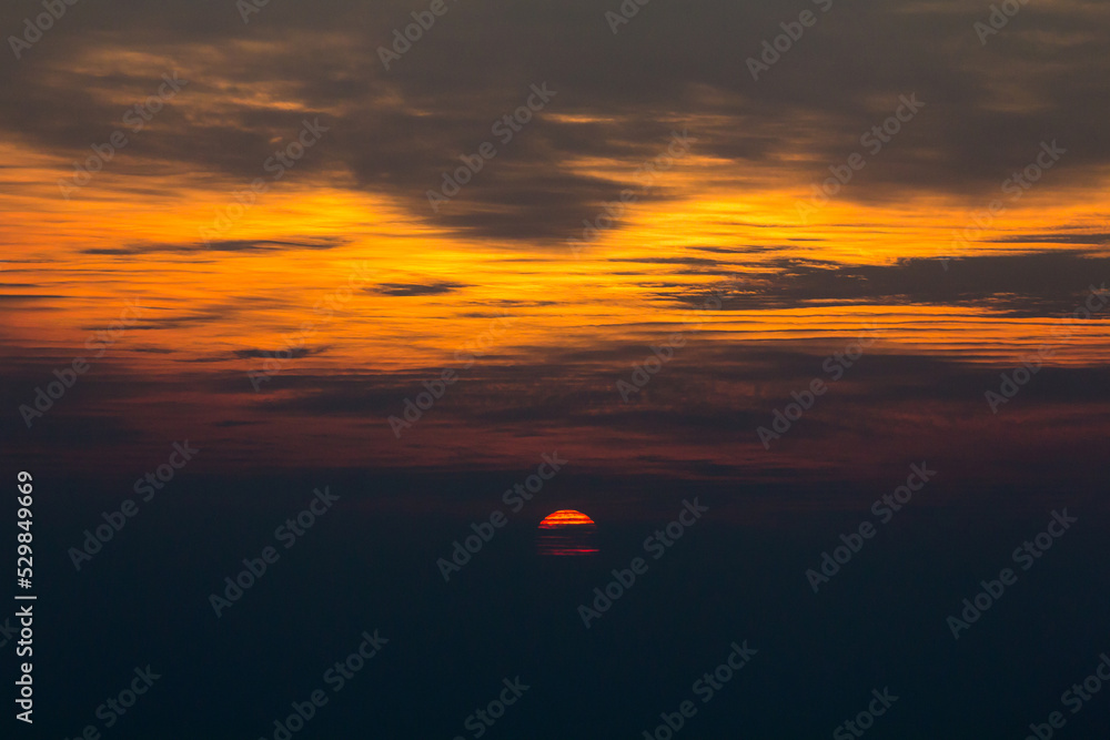 The setting sun that looks deformed due to the mirage The setting sun that looks deformed due to the mirage