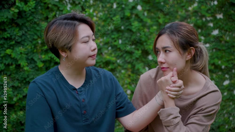 4K, Two Asian lovers are sitting together and teasing with love and happiness in their new backyard where they live happily ever after. Love and friendship of LGBTQ couples 4K, Two Asian lovers are sitting together and teasing with love and happiness in their new backyard where they live happily ever after. Love and friendship of LGBTQ couples