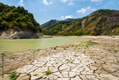 Dry lake bed with a natural texture of cracked clay on the ground. 