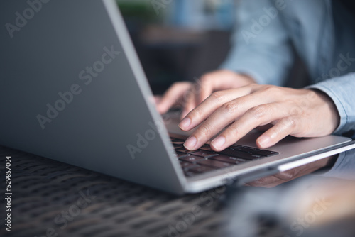 Woman hands typing on laptop computer on table at office. Female worker, freelancer online working from cafe, remotely work