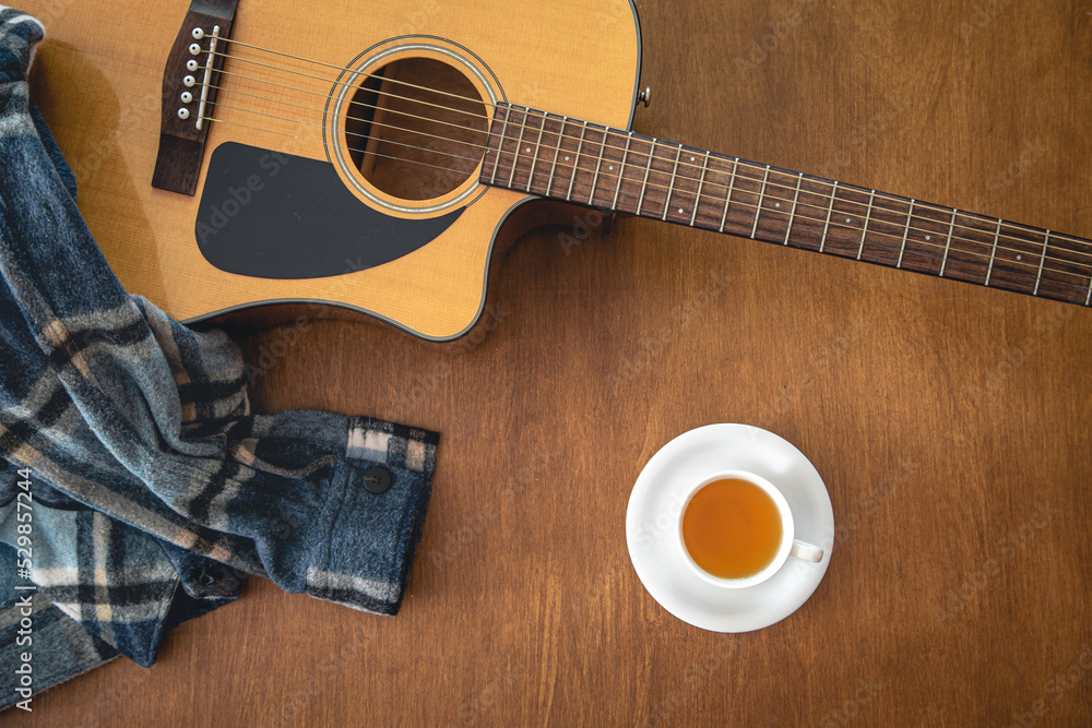 Obraz premium Music background with acoustic guitar, top view.