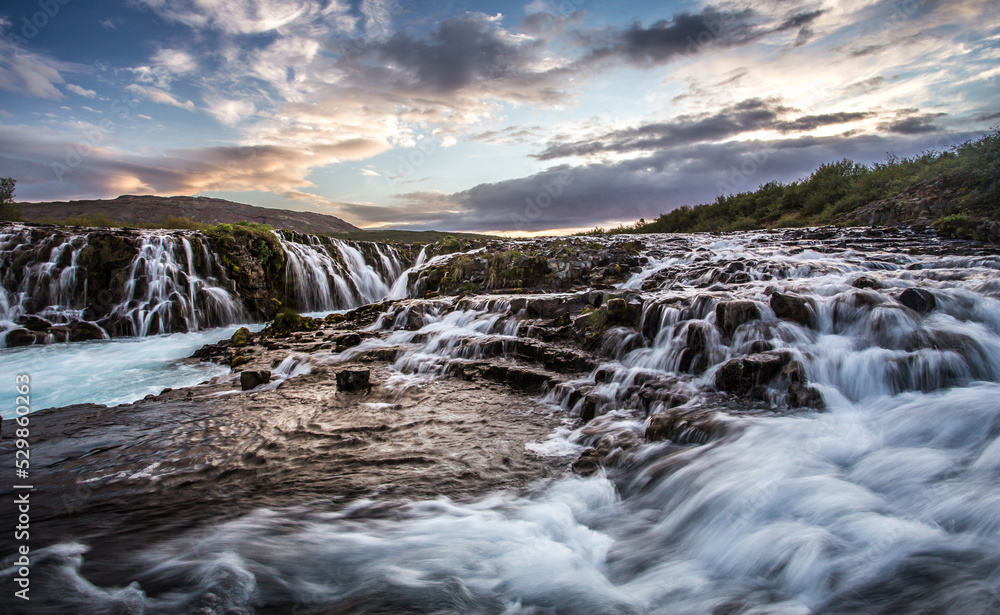 Fantastic Bruarfoss Waterfall. Amazing nature of Iceland. Iceland popular place of travel and touristic location. Wonderful Icelandik landscape during sunset. Creative image. Natural background