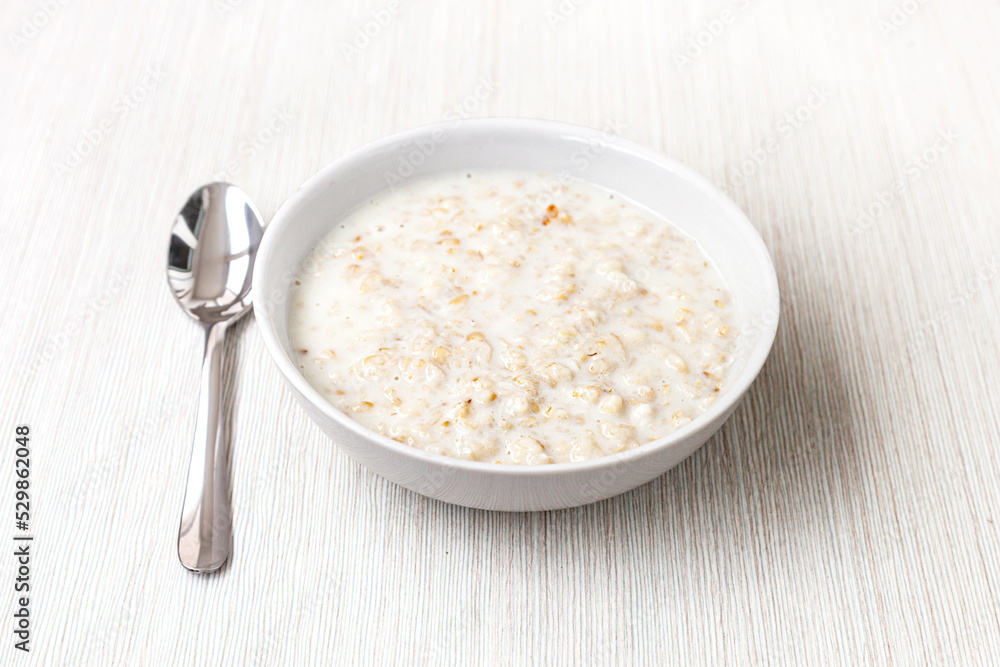 oatmeal in milk - light background oatmeal in milk - light background