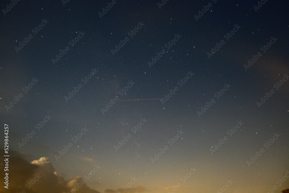 Naklejka premium Plane In The Night Sky.