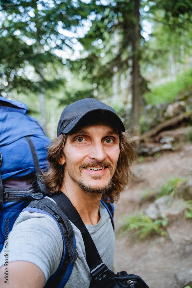 A guy goes on a hike taking pictures of himself on his phone, a young man took a selfie, smiles at the camera, a bearded hipster in the woods self-portrait, A guy goes on a hike taking pictures of himself on his phone, a young man took a selfie, smiles at the camera, a bearded hipster in the woods self-portrait,