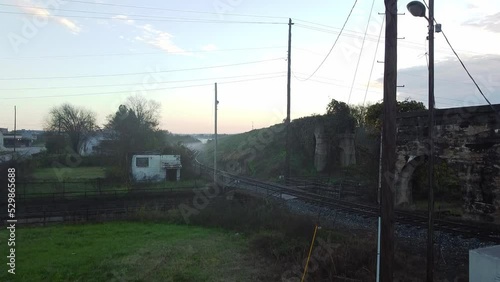 Crane shot over mist covered train tracks at sunrise in rural Macon Georgia