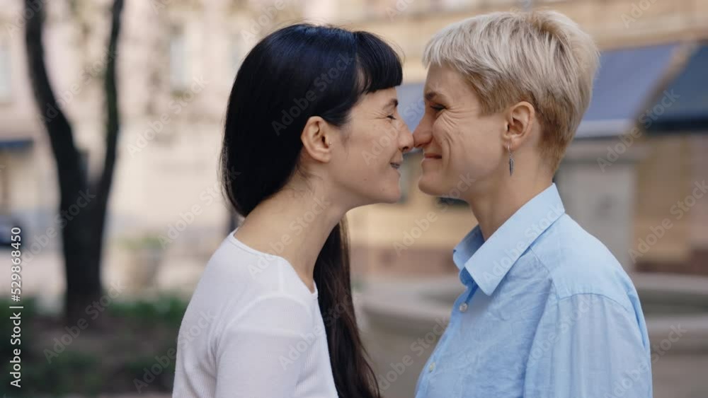 Two pretty women in love laughing and rubbing noses close-up. Beautiful lesbian couple enjoying together. Romantic date, love, tender relationship concept Two pretty women in love laughing and rubbing noses close-up. Beautiful lesbian couple enjoying together. Romantic date, love, tender relationship concept