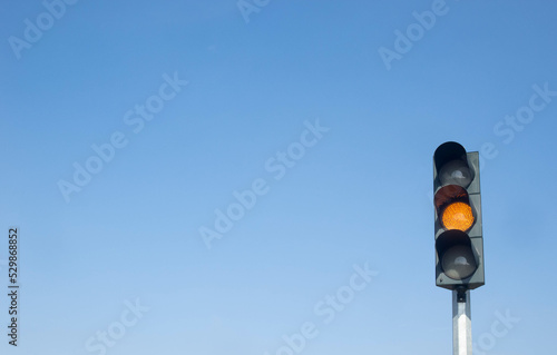 Traffic lights, traffic lights that turn on show orange or yellow lights as a warning sign. Isolated on a clear sky background