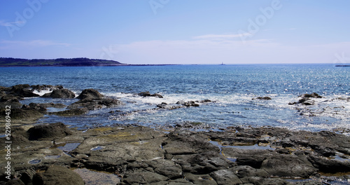 Sea over the rock beach in sunny day